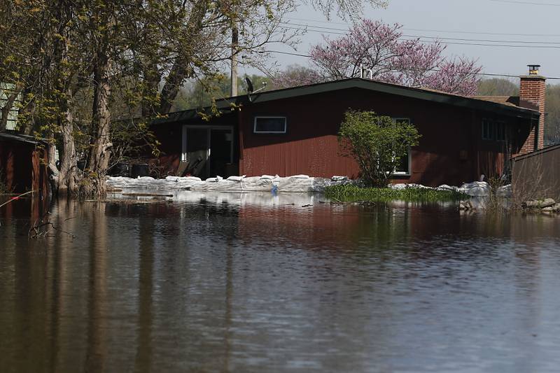 Sandbags protect a home in Holiday Hills  as flooding continues on the Fox River on Wednesday, April 22, 2026.