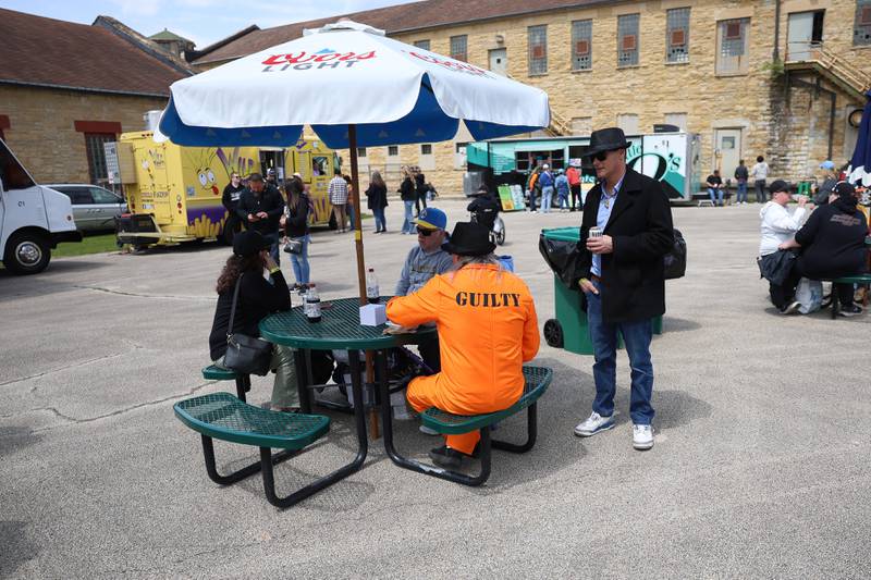 A fan dress in prison garb has lunch in the food court before the Joliet Slammers preseason game at the Old Joliet Prison on Thursday, April 29, 2026 in Joliet.