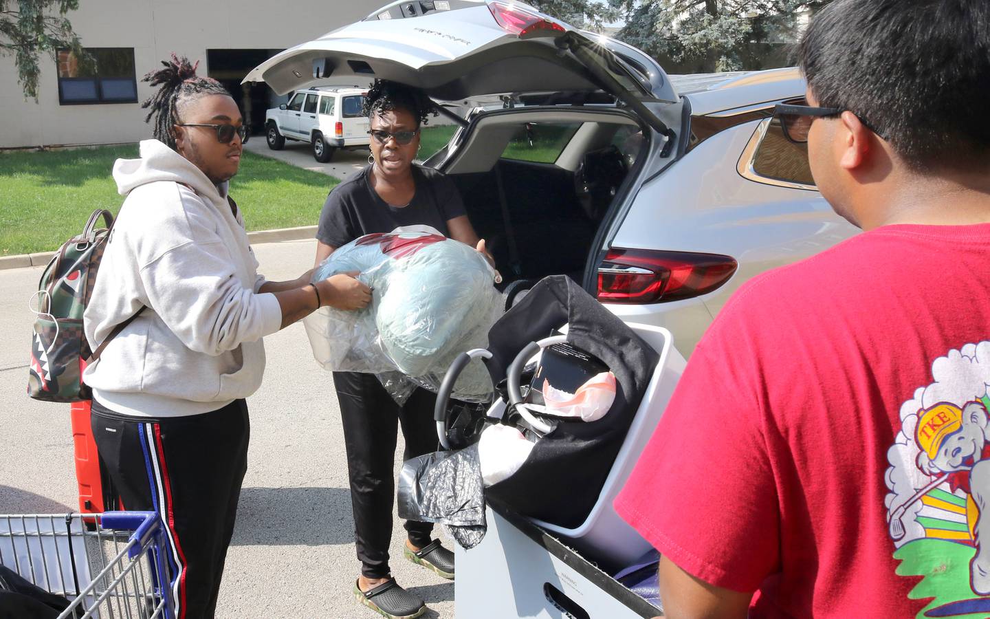 Northern Illinois University freshman Terrence Bradley, from Chicago, gets a hand from his mom Jeena as they unload things to move into his room Wednesday, Aug. 23, 2023, during move-in day in front of the Fanny Ruth Patterson Complex at NIU in DeKalb.