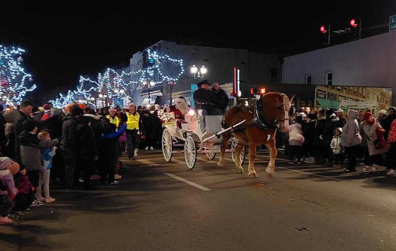 Santa makes his way down La Salle Street to conclude the Festival of Lights parade Friday, Nov. 24, 2023, in Ottawa.