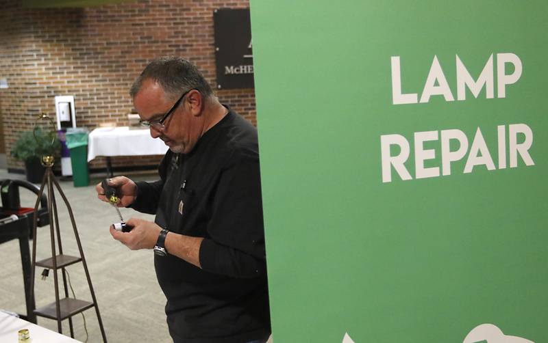 Chris Fleming, of McHenry County College, replace a light socket in a lamp during a Repair Fair on Tuesday, April 15, 2025, at McHenry County College.