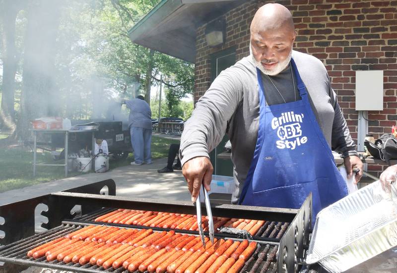 Darren Glasper cooks up some hot dogs for New Hope Missionary Baptist Church, who gave away free food and drinks during the second annual Juneteenth celebration Sunday, June 19, 2022, at Hopkins Park in DeKalb.