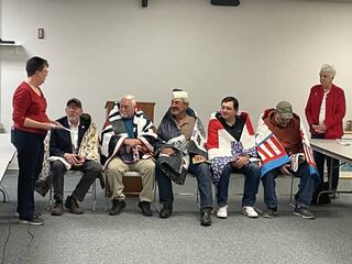 Terry Johnson (left) and Martha Patelli (right) speak to Quilts of Valor recipients Bill Hunt, Mick Hartley, Harold Olsen, Nick Brolley and Joe Arjes at the ceremony in La Salle.
