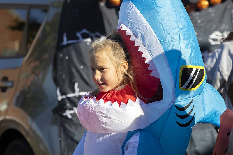 Shark attack victim Kenzie Kibble, 9, finds time to gather candy Saturday, Oct. 26, 2024, in Dixon.