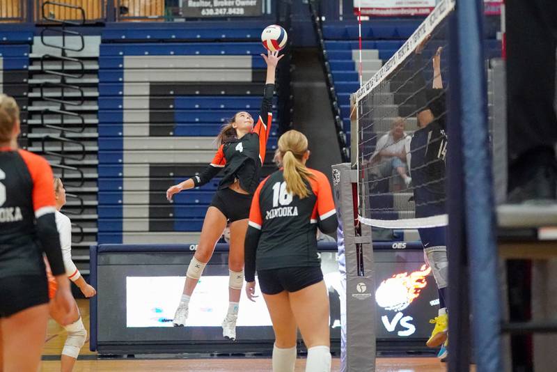 Minooka's Jerzie Caves (4) plays the ball at the net during a Southwest Prairie Conference match against Oswego East in Oswego on Thursday, Sept. 18, 2025.