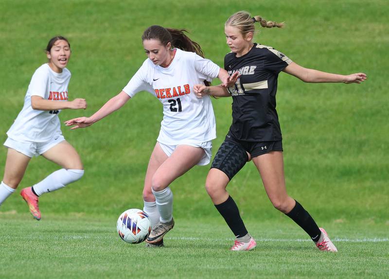 DeKalb's Quinn McLane tries to hold off Sycamore's Kelsie Ryder Thursday, May 7, 2026, during their game at Sycamore High School.