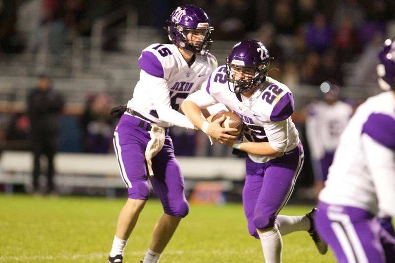Dixon's Tyler Shaner hands the ball off to Aiden Wiseman against Genoa- Kingston on Friday Oct.7,2022 in Genoa.