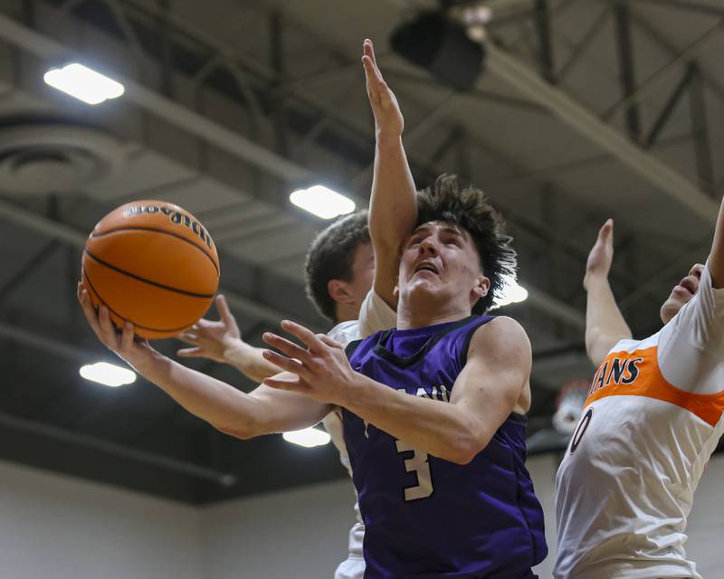 Plano's Ethan Taxis (3) is fouled as he hangs in the air on a layup attempt during their basketball game between Sandwich at Plano Tuesday, Jan 27, 2026 in Sandwich.