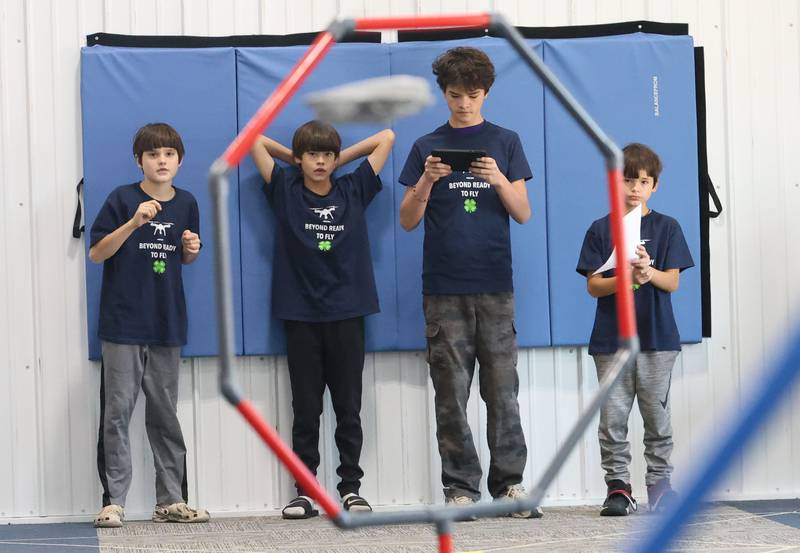 (From left) William, Elijah, Noah and Samuel Gross of Peru,  help fly their drone through obstacles during a drone compompetition on Saturday, Nov. 22, 2025 at the Second Story Teen Center in Princeton. Teams from Bureau, La Salle and Marshall-Putnam counties came together to showcase their flying skills during the event. Second Story Teen Center partnered with the University of Illinois Extension of Bureau, La Salle Marshall and Putnam Counties. Drones and awards were purchased through a grant and donations from Compeer Financial.