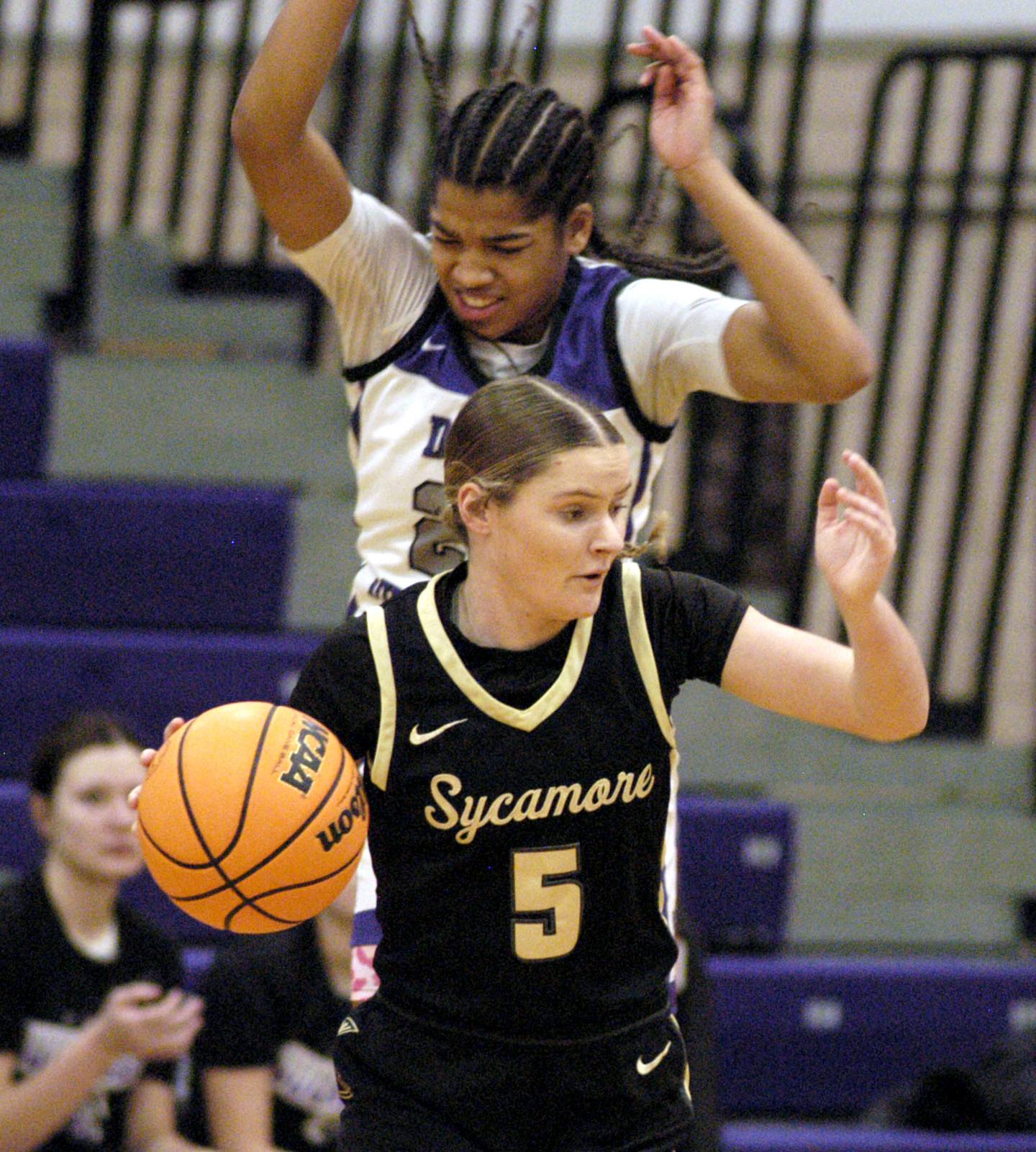 Dixon's Ahmyrie McGowan applies pressure to Sycamore's Grace Amptmann. The Dixon Duchesses beat the Sycamore Spartans 55-47 in a non-conference game played at Lancaster Gym in Dixon on Saturday, December 20th, 2025.