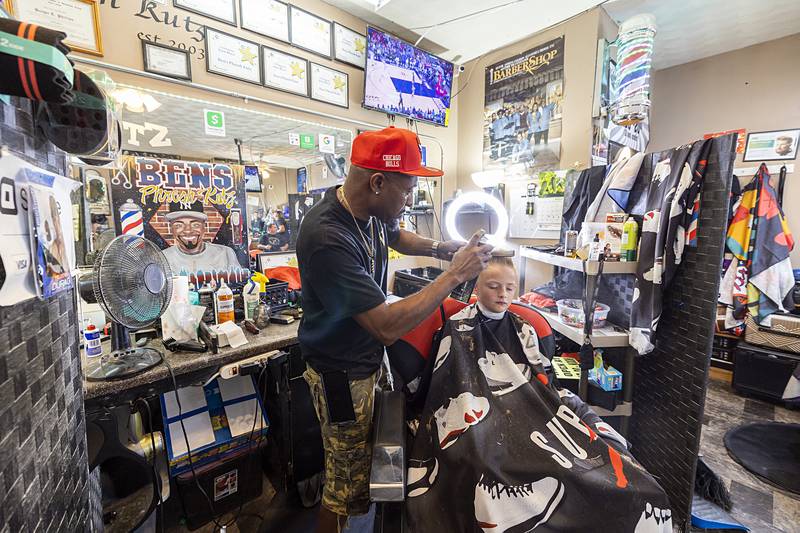 Ben Phillips gives Colton Lee, 7, a fresh new cut Tuesday, July 30, 2024 at Ben’s Phresh Kutz in Rock Falls. Phillips is gearing up for their Back 2 School Bash, an event held at the Rock Falls Community Building that offers $7 haircuts and back to school supply giveaways.
