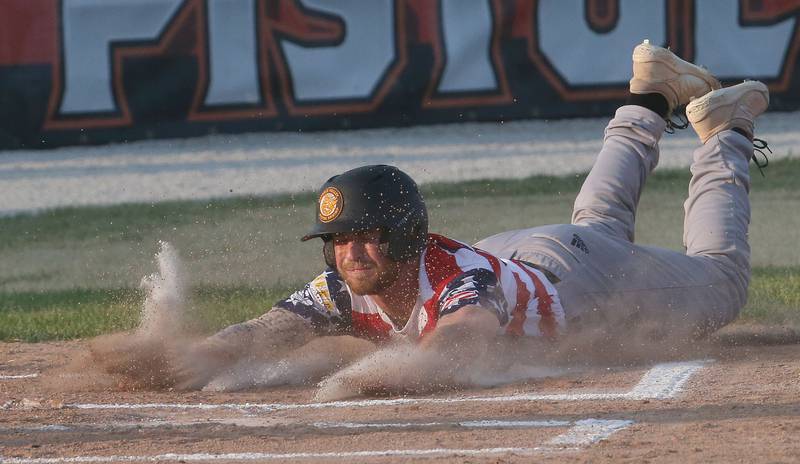 Illinois Valley Pistol Shrimp's Tyler Dorsch slides safely into home plate to score a run against the Normal Cornbelters during the Illinois Valley Pistol Shrimp baseball game at Schweickert Stadium on Tuesday, June 20, 2023 in Peru.