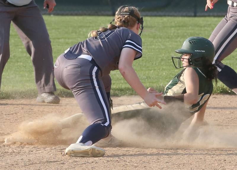 St. Bede's Bailey Engles slides underneath the tag of Ridgewood AlWood/Cambridge's Courtney Thomas in the Class 1A Sectional semifinal game on Tuesday, May 23, 20223 at St. Bede Academy.