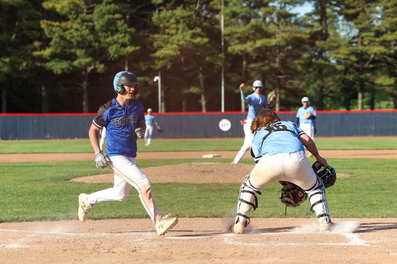 Clifton Central's Graysen Boudreau beats the throw to Kankakee catcher Devin Arbour to score a run during Central's 8-4 victory over Kankakee on Monday, May 11, 2026.