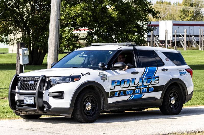 Elwood Police officers sit in a car in the driveway of the Joliet Local Training Area site for the Illinois National Guard at 20612 Arsenal Road in Elwood on Wednesday, October. 8, 2025.