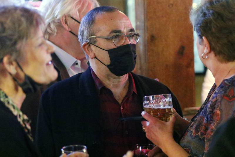 Incumbent acting Crystal Lake mayor Haig Haleblian, center, meets with supporters during an election night watch party at The Cottage on Tuesday, April 6, 2021 in Crystal Lake.