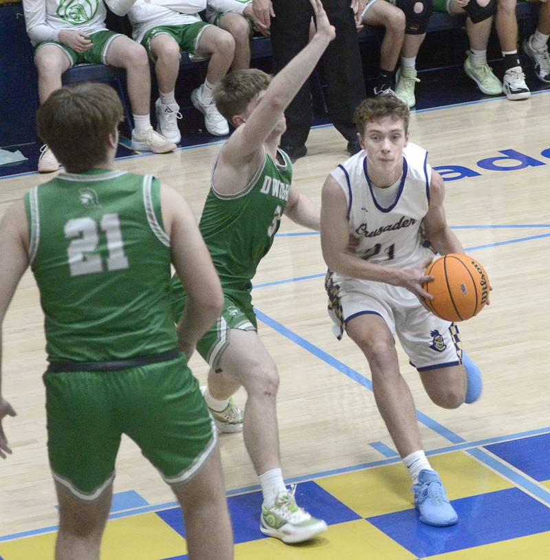 Heading towards the basket Marquette’s Lucas Craig  drives past Dwight’s Collin Bachand  in the 1st period Monday at Marquette.