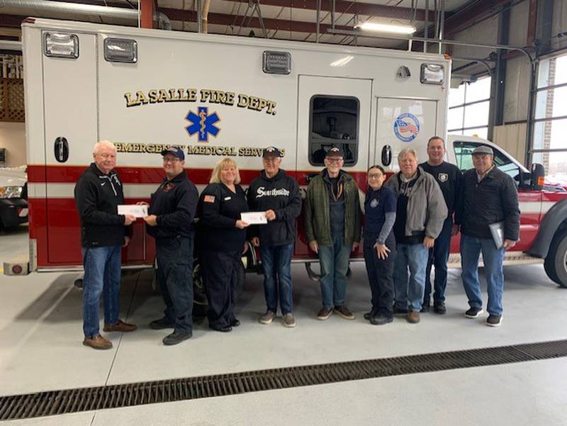The Utica Fireside White Sox Club presented $1,000 checks to the La Salle and Oglesby Fire Departments on Dec. 29, 2023. From left are club president Lew Cushing, Jason Phillips of La Salle Ambulance, Oglesby Ambulance director Cathie Edens, club treasurer Randy Tuftie, club member Jim Ferrero, Kris Hafley of La Salle Ambulance, and club members Paul Danekas, Rich Vollmer and Robert "Bo" Windy.