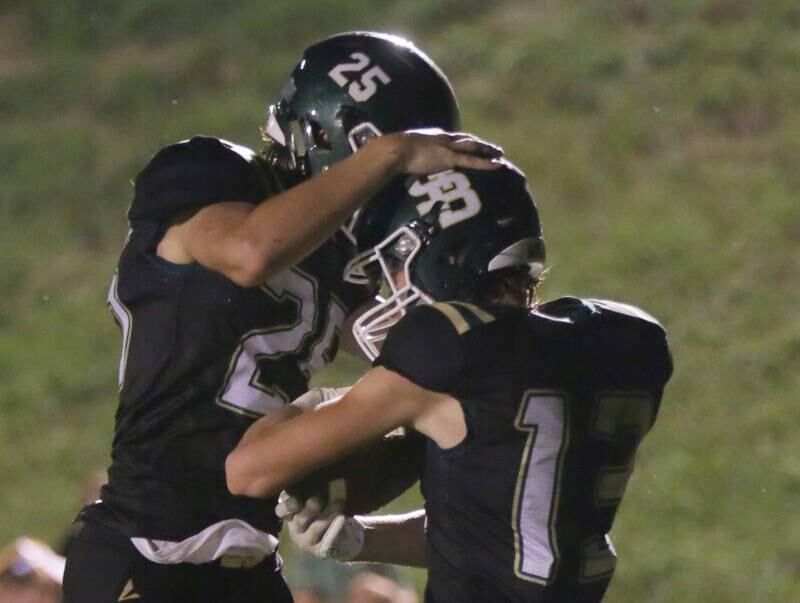 St. Bede players Landon Jackson (25) celebrates with his teammate Ben Wallace (13) after scoring a touchdown against Kewanee on Friday, Sept. 9, 2022 at the Academy in Peru.