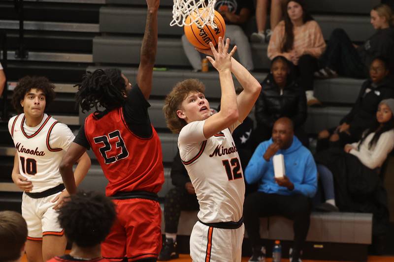 Minooka’s Zane Caves put up the shot against Bolingbrook on Tuesday, Dec. 17, 2024 in Minooka.