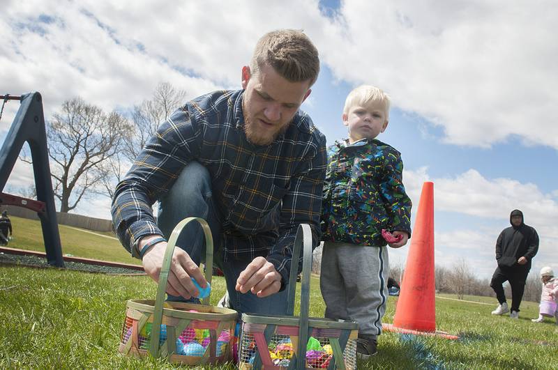 Michael Zorek and son Silas, 2, go through their loot Saturday, April 16, 2022 at the drop.