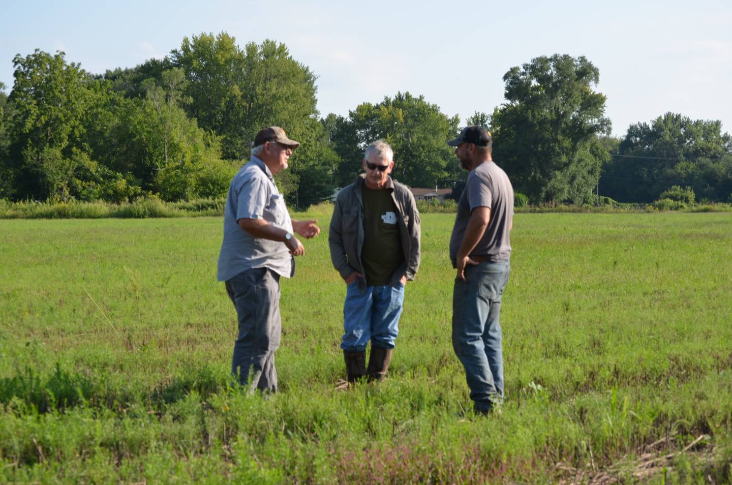 Conservationists, from left, Dean Huisingh, Dave Harrison, and Brian Langloss, from left, stand in a future prairie off Elston Road in Fulton on Sept. 2. The three have been converting a former corn and soybean field to prairie and are part of a team working to bring the Whiteside County Conservation Education Center to a plot of land along Elston Road.
