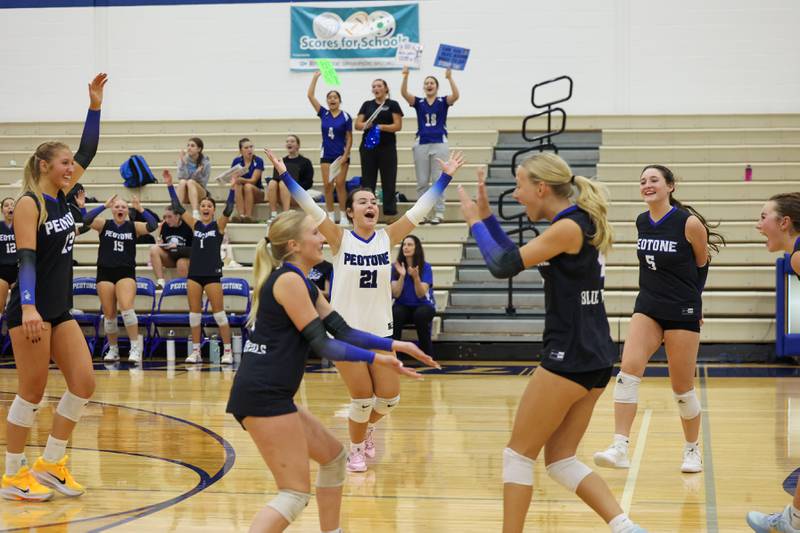 Peotone's Ella Stupegia, center, celebrates winning the first set with teammates during the Blue Devils' loss in three sets, 19-25, 25-19, 25-21, to Manteno on Tuesday, Sept. 23, 2025.