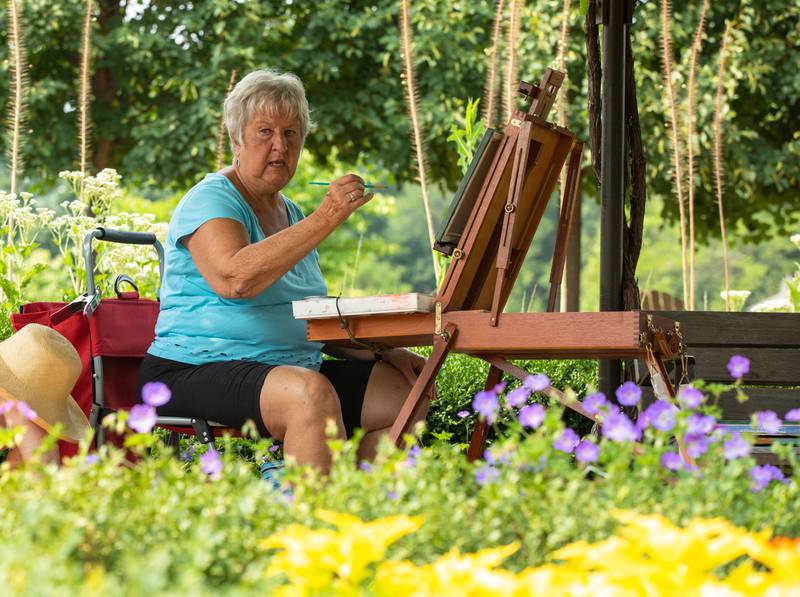 Painter Marge Hall paints a floral portrait during the Voyage en France Fest at Cantigny in Wheaton on Sunday, July 16, 2023.
