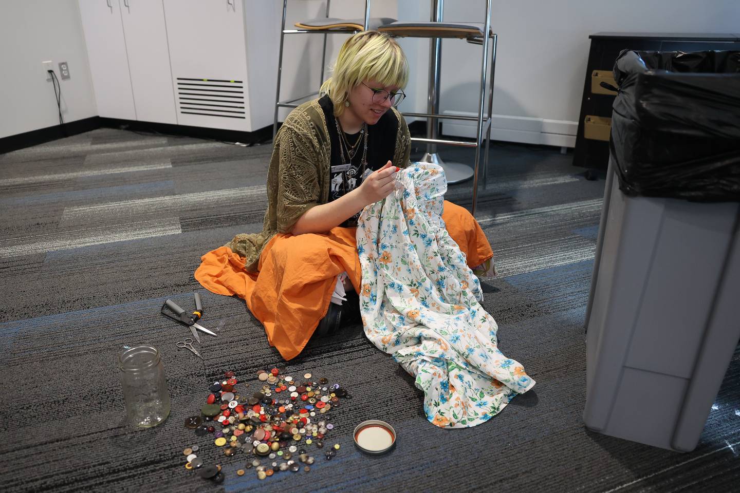 Janna Stub, a JJC Fine Art student with a focus on Costume Design, replaces buttons on a dress during the Repair Cafe event at the Joliet Junior College Romeoville campus on Saturday, April 13, 2024.