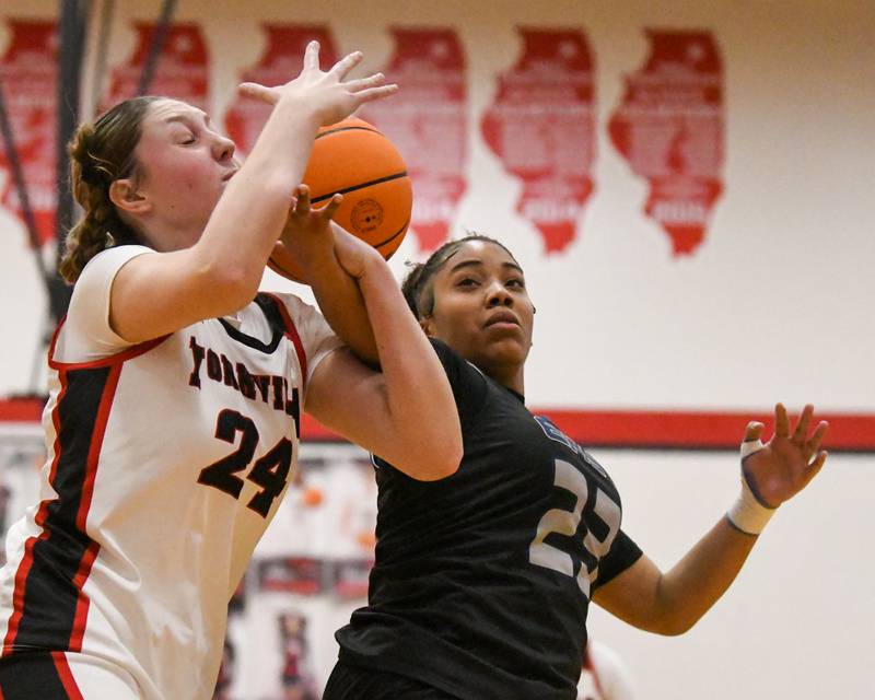 Yorkville's Sloane Connell (24) and Oswego East's Inspire Fisher (23) battle for a loose ball during the game on Thursday Dec. 18, 2025, held at Yorkville High School.