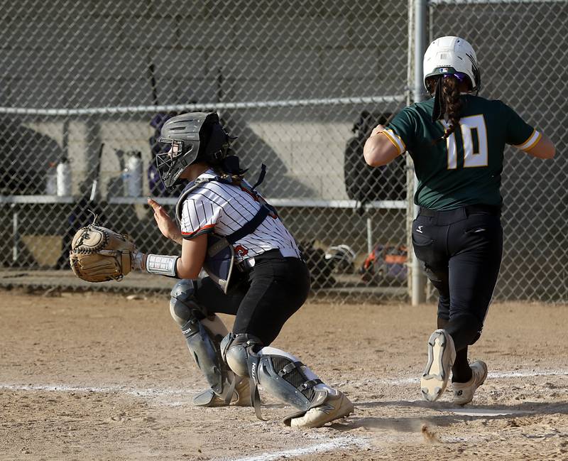 Crystal Lake South's Alexis Pupillo scores Arun as McHenry's Emma Stolzman waits for the throw during a Fox Valley Conference softball game Monday, May 9, 2022, between McHenry and Crystal Lake South at McHenry High School.