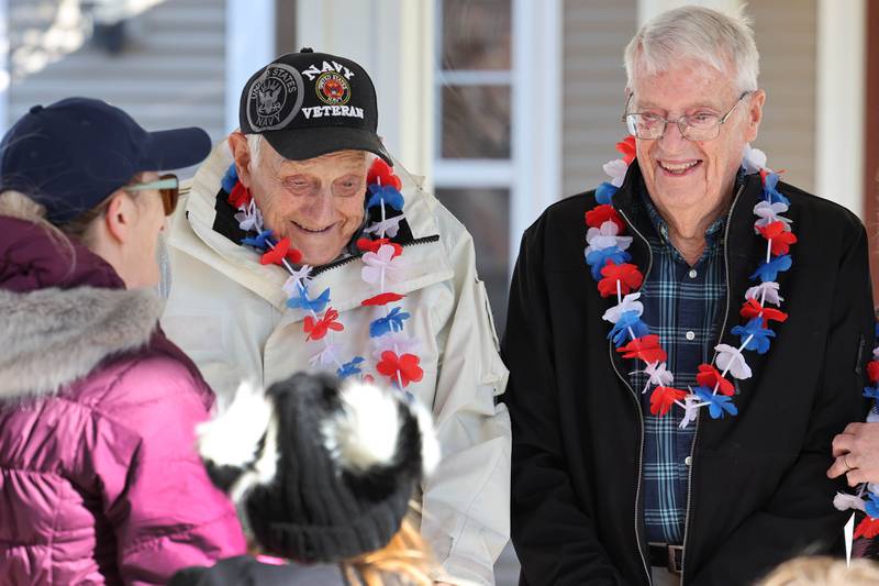 US Navy veteran Richard Korleski, (left) 93, and Ken Cooper, 96, a US Army veteran, smile as talk to members of the Kunkel family after they put on a small bike parade on Veterans Day,  Friday, Nov. 11, 2022, at the Grand Victorian assisted living facility in Sycamore. Sycamore resident Joann Kunkel read a story in the current Midweek that contained a quote from one of the veterans at the facility that lamented the lack of a parade. So she and her grandkids decided to have one for them.