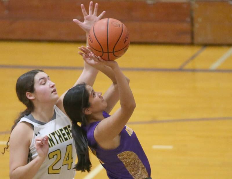 Mendota's Crystal Garcia manges to score on a drive to the basket as Putnam County's Maggie Richetta defends during the Princeton High School Lady Tigers Holiday Tournament on Tuesday, Nov. 14, 2023 in Prouty Gym.