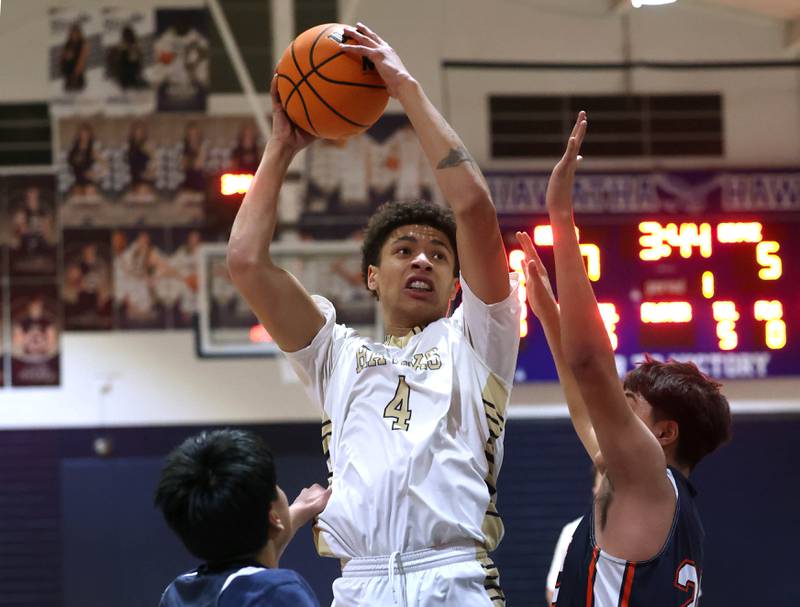 Hiawatha’s Elijah Beaver grabs a rebound in front of two DePue defenders during their game Tuesday, Jan. 20, 2026, at Hiawatha High School in Kirkland.