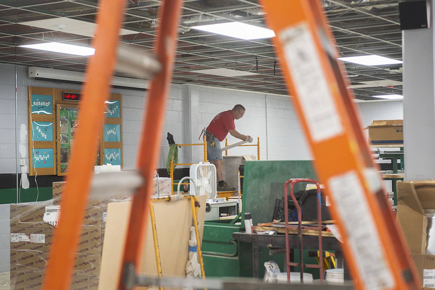 Joel Plum of Gehrke Construction works on the ceiling tiles Wednesday, July 27, 2022 in Rock Falls High School’s renovated cafeteria. The kitchen and dining area has undergone extensive updating.