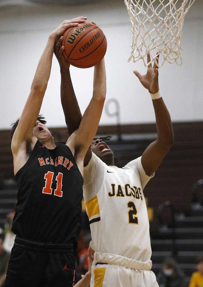 McHenry's Hayden Stone battle with Jacobs' Treval Howard for a rebound during a Fox Valley Conference basketball game Wednesday, Dec. 7, 2022, between Jacobs and McHenry at Jacobs High School in Algonquin.