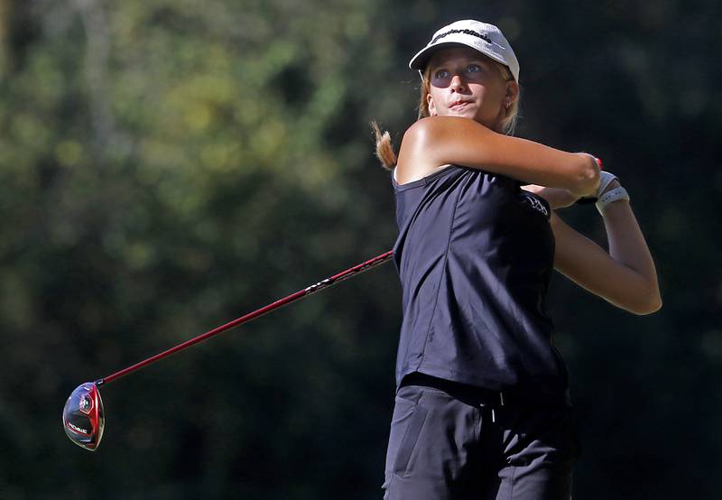 Prairie Ridge’s Jenna Albanese watches her tee shot on the 5th hole during the Fox Valley Conference Girls Golf Tournament Wednesday, Sept. 25, 2024, at Crystal Woods Golf Club in Woodstock.