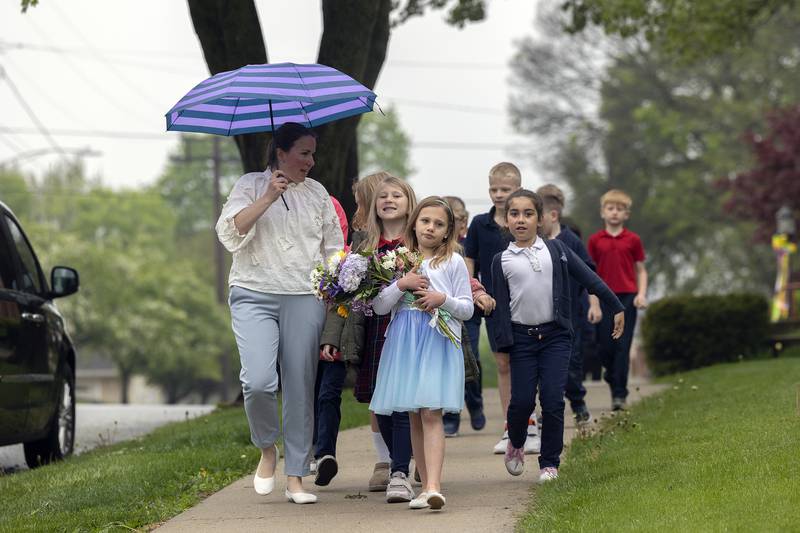 St. Mary’s students proceed to the school Thursday, May 1, 2025, after a May Crowning celebration at St. Patrick’s Church in Dixon. The day is observed as a time of devotion to the Blessed Virgin Mary by offering a crown of flowers to an image of Mary.