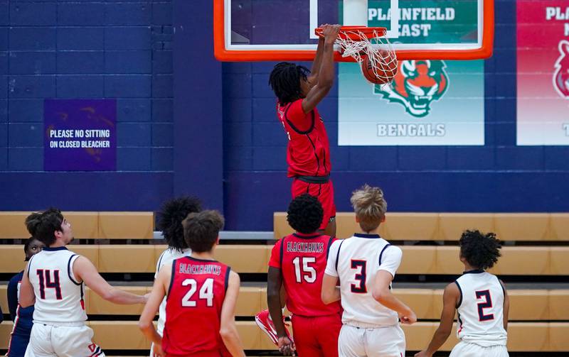 West Aurora's Terrence Smith (5) dunks the ball off of a fast break against Oswego during a basketball game at Oswego High School on Friday, Dec 1, 2023.