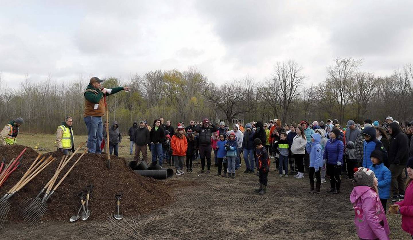 Forest Preserve District of Kane County Executive Director Benjamin Haberthur speaks to volunteers who were there plant 500 trees in honor of Earth Day Saturday at Tekakwitha Woods Forest Preserve in St. Charles.