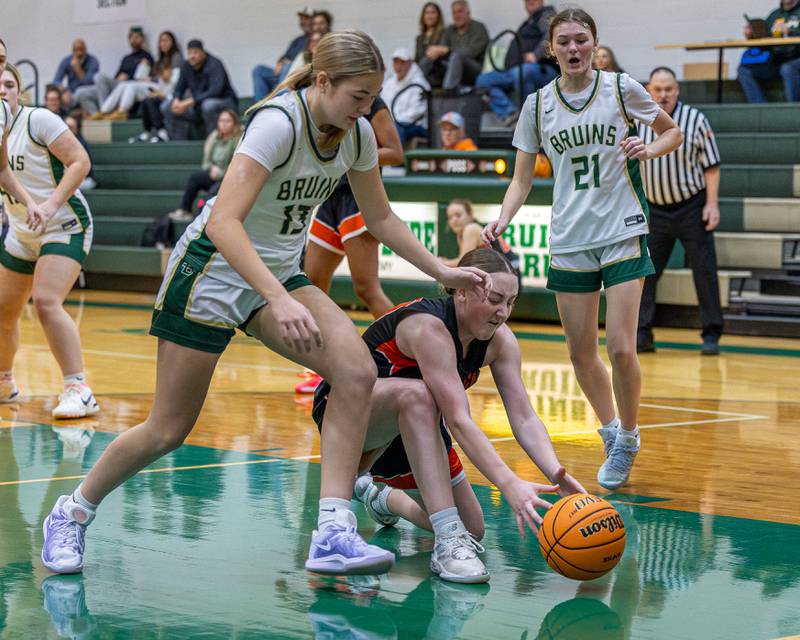 Kayden Corneils (10) of Sandwich gets on floor to grab loose ball as Tula Rue (13) of St. Bede trails during the Lady Bruins Christmas Classic on Saturday, December 27, 2025 at St. Bede Academy in Peru.