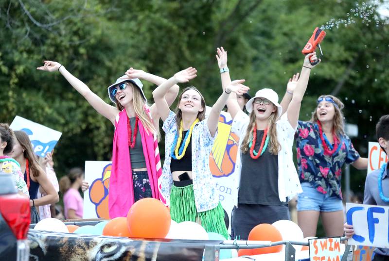 Wheaton Warrenville South swimmers participate in the school’s homecoming parade on Wednesday, Sept. 21, 2022.