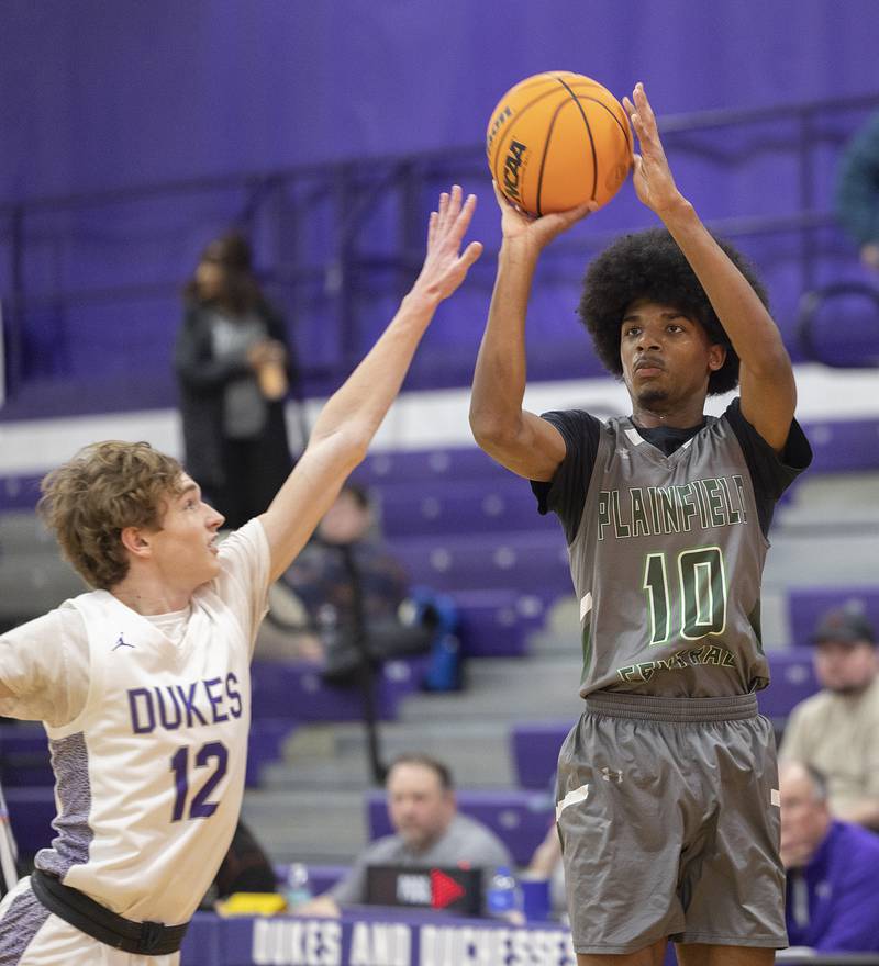 Plainfield Central’s Alexis Landfair puts up a shot over Dixon’s Gabe Rowley Friday, Jan. 3, 2025, at Dixon High School.