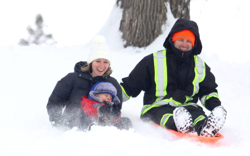 Abigail and Joe Walsh of Crystal Lake sled with their son Holden, 2, at Veteran Acres on Sunday, Dec. 7, 2025 in Crystal Lake.