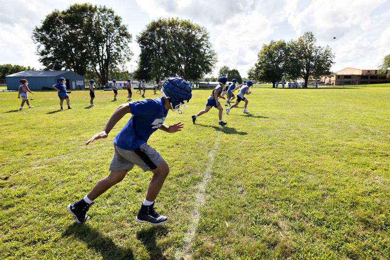 Newman players practice special team drills Tuesday, August 12, 2025, at the high school. The team is gearing up for the 2025 season.