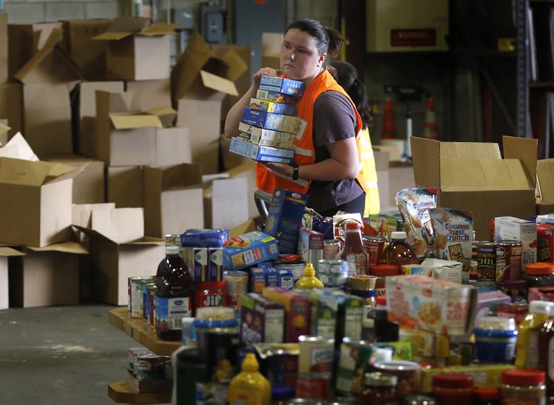 Marissa Rybinski, of McHenry County Department of Health, sorts items during the Operation Dropbox Exercise on Tuesday , June 11, 2024, at the McHenry County Division of Transportation near Woodstock. The training exercise simulates the process of unloading and distributing medical counter-measures during emergencies along with helping to sort and distribute the donated items to veterans and their families in the county.
