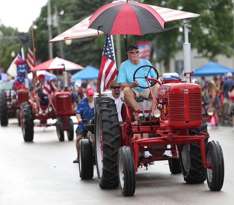 Vintage tractors make their way down Main Street Friday, July 4, 2025, during the Fourth of July parade in downtown Kirkland.
