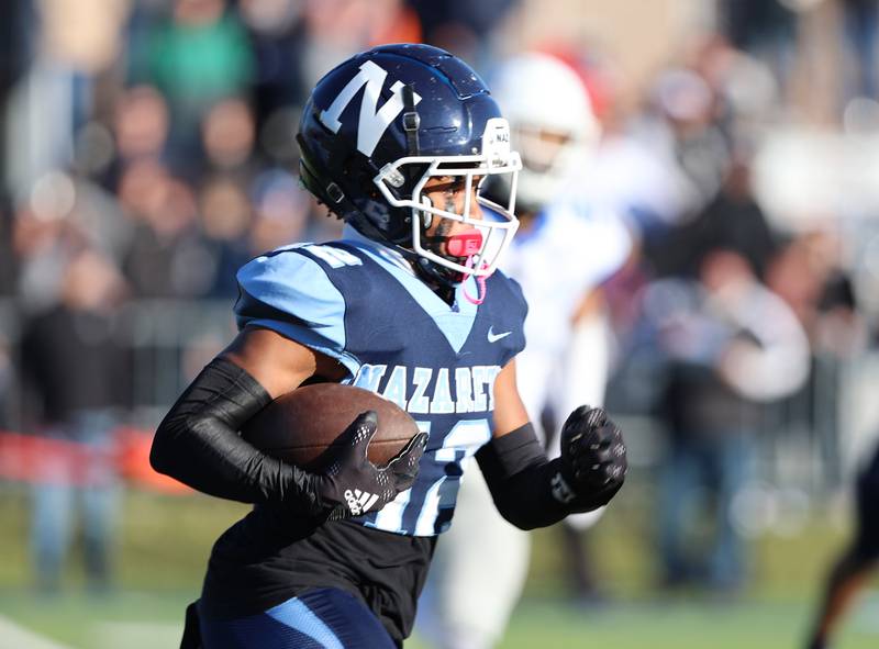 Nazareth's Edward Mcclain Jr. (12) returns a kick against St. Francis during the boys varsity IHSA 5A semifinal between Nazareth Academy and St. Francis high school in La Grange Park, IL on Saturday, Nov. 18, 2023.