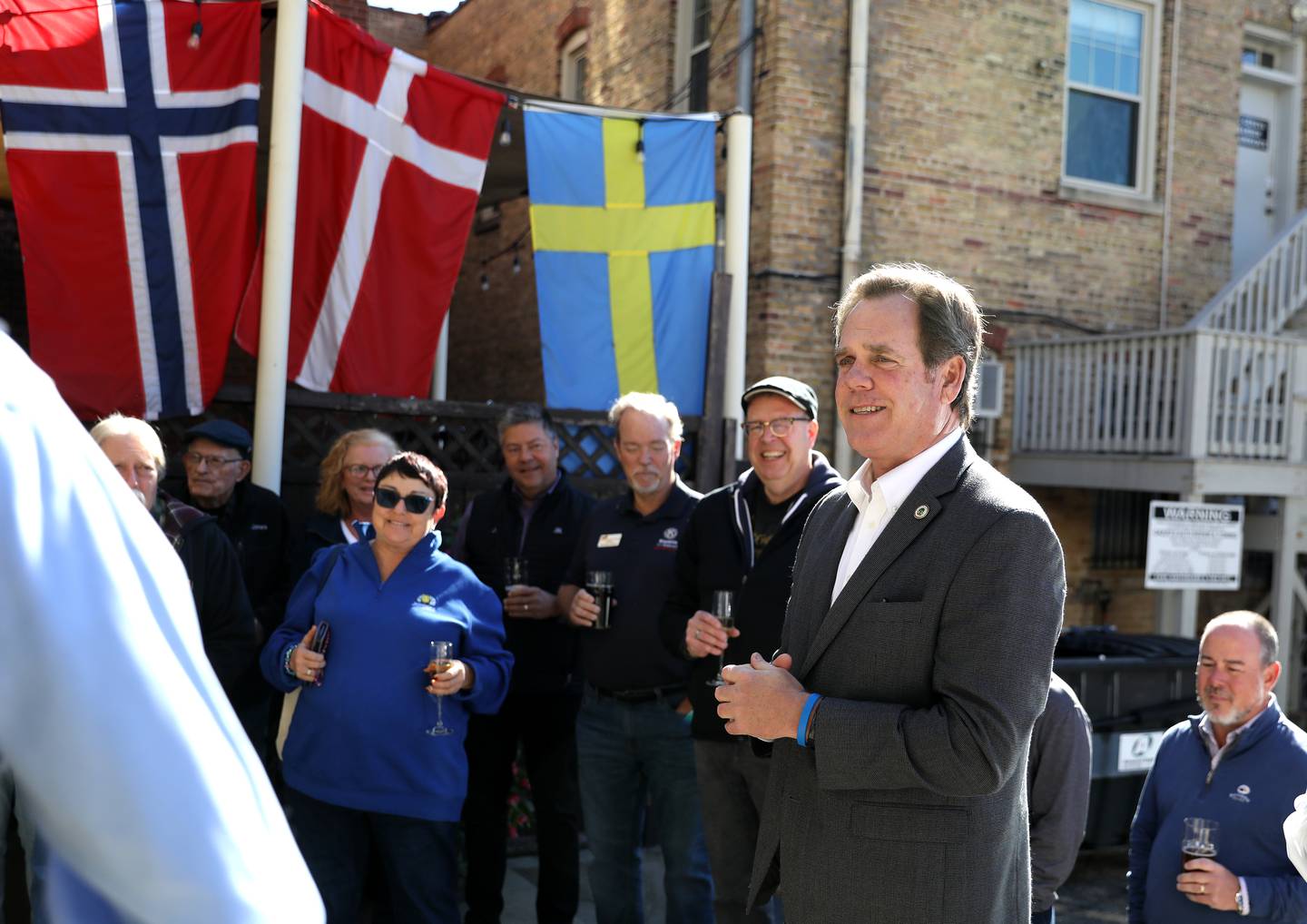 Geneva Mayor Kevin Burns speaks outside Stockholm’s Restaurant and Brewery in Geneva on Wednesday, Oct. 16, 2024 for a reopening ceremony. The restaurant was closed temporarily following a July fire.