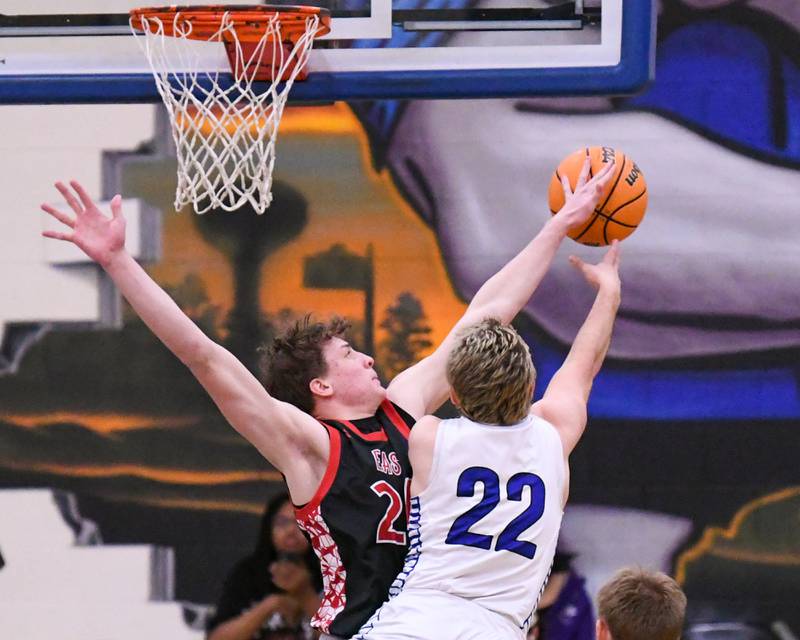 Glenbard East's Sam Walton (24)  blocks the shot of Riverside-Brookfield's Benjamin Biskupic (22) during the game on Tuesday Feb. 3, 2026, held at Riverside-Brookfield High School.